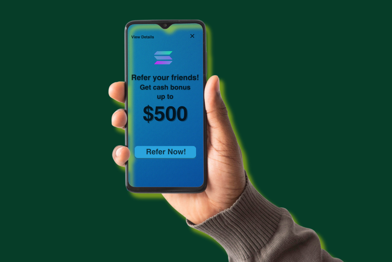 A hand holding a phone displaying up to $500 cash bonus offer for referring a friend.