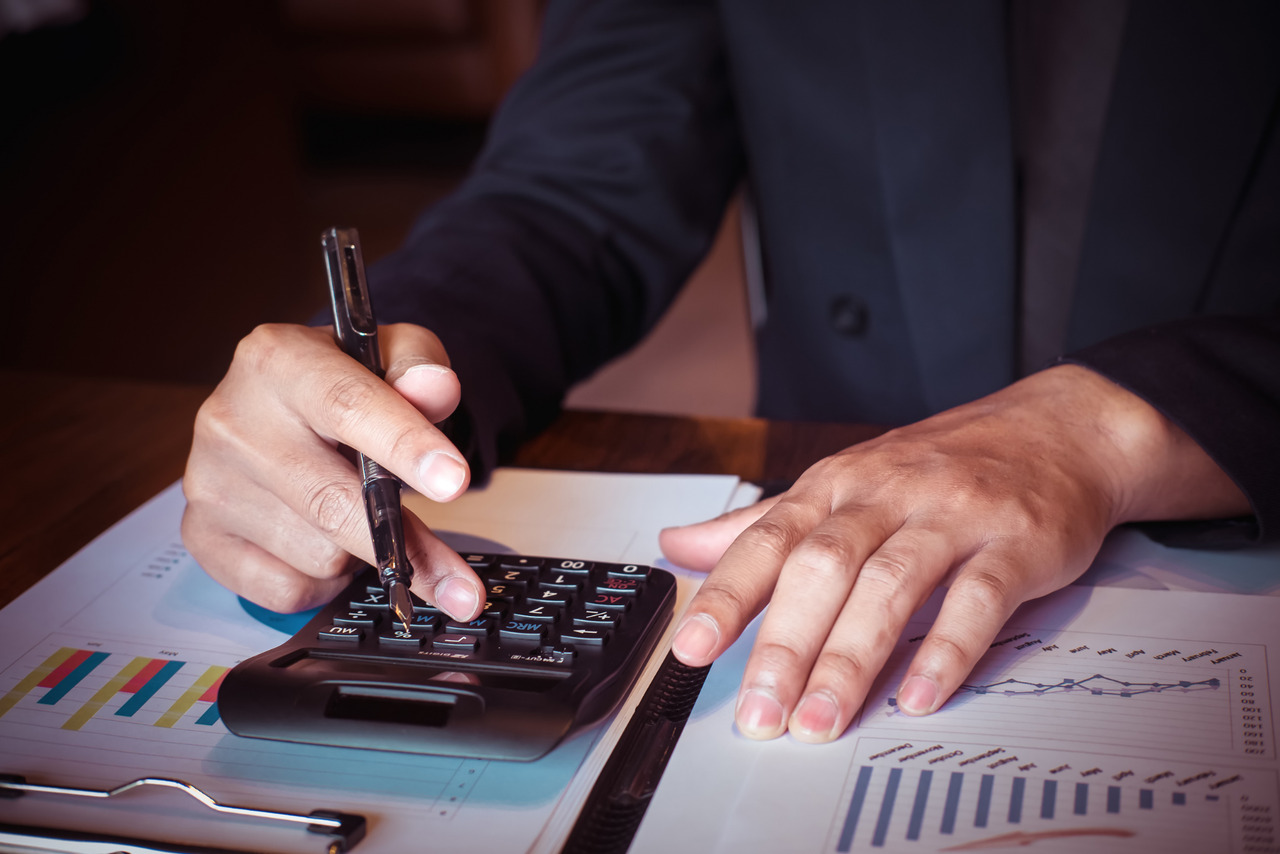 Business owner calculating expenses for new technology.