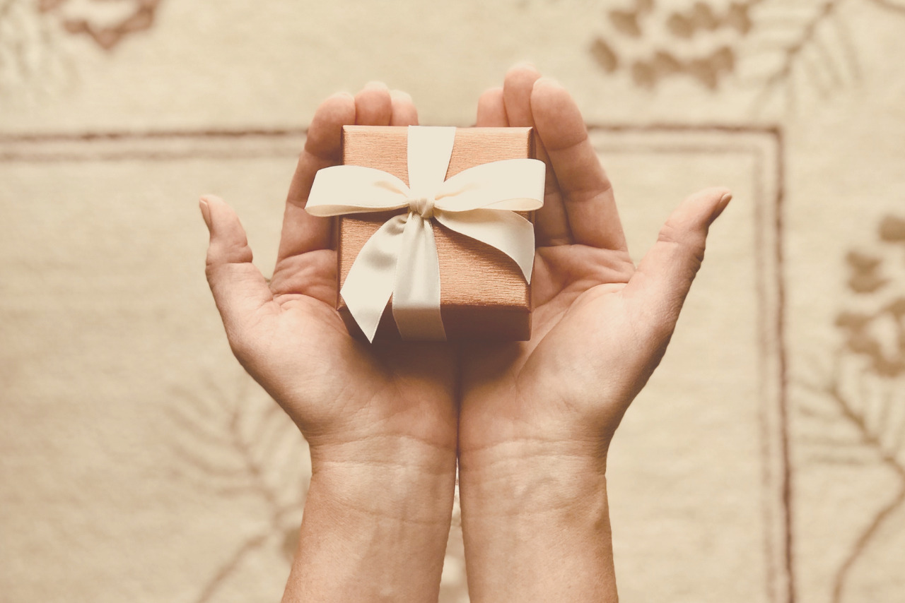 Person Holds Brown Gift Box.