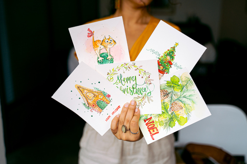Close-Up Shot of a woman Holding Christmas Cards.