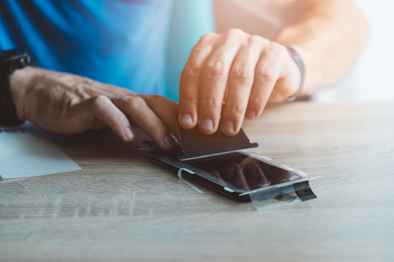 Man applying protective screen protector.