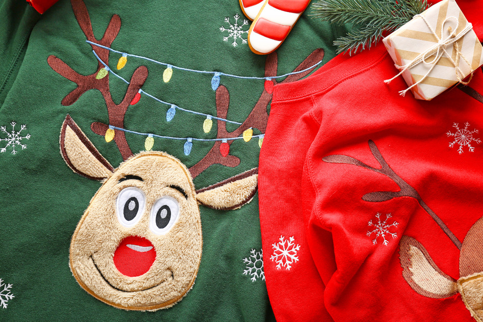 Funny Christmas Sweaters on Table.