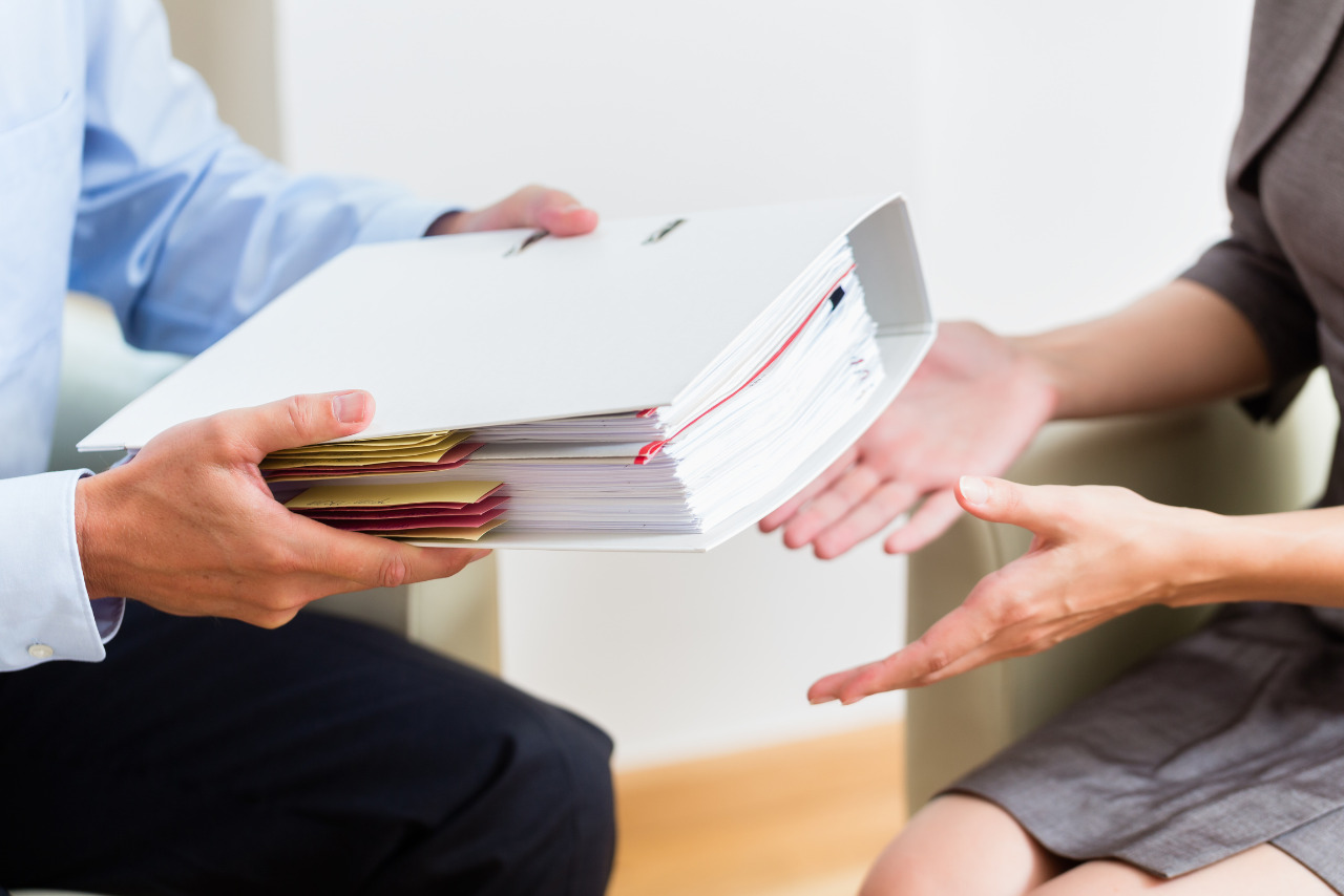 Seller handing over business documents to new owner.
