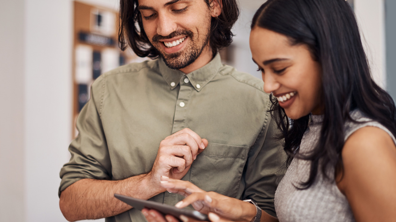 Two users happily use WordPress for its user-friendly interface.