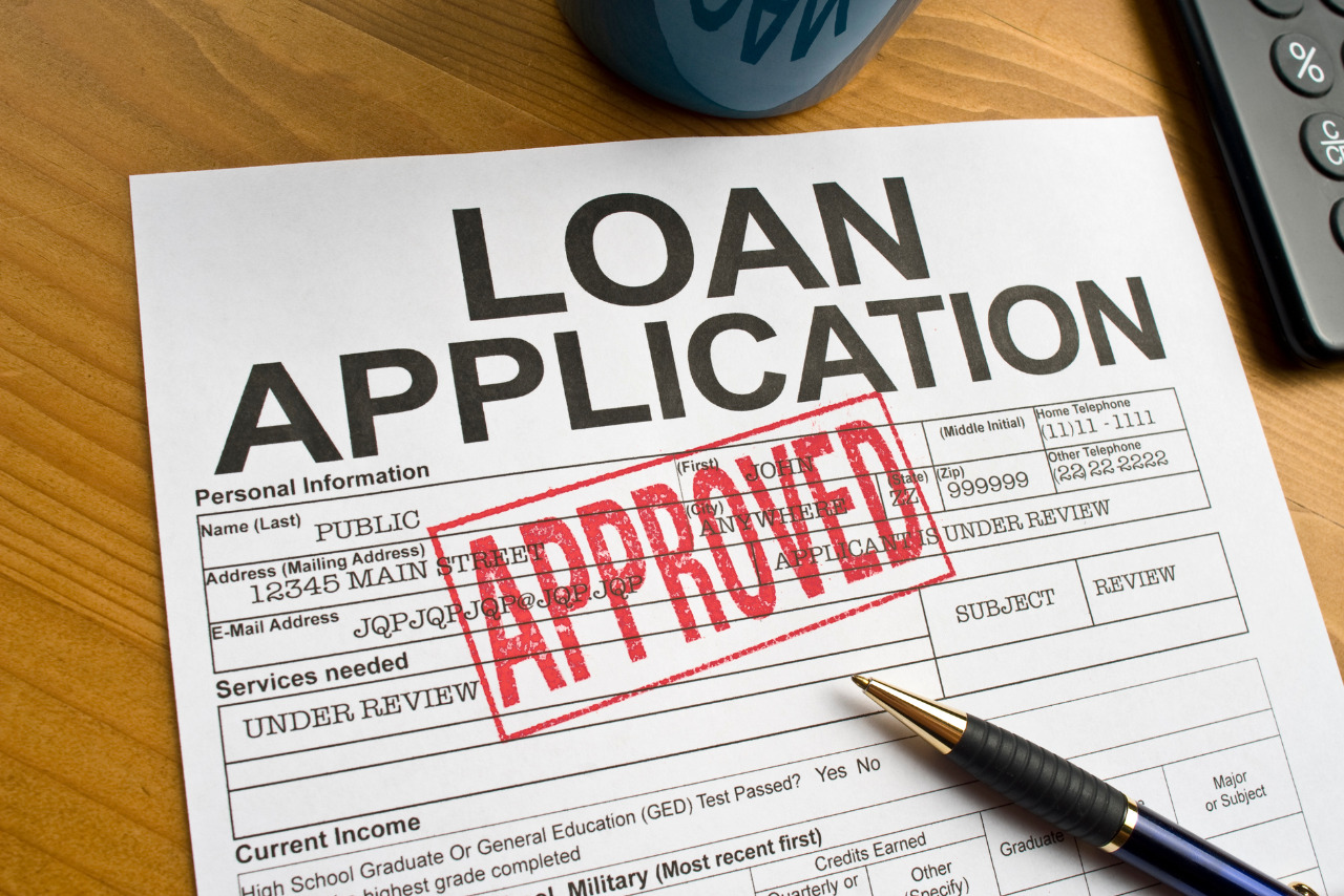 Approved loan paper on desktop table.