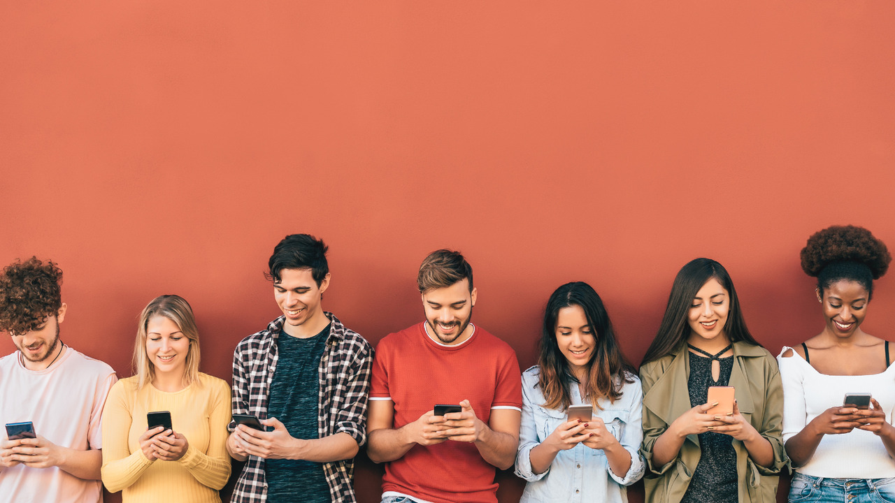 Diverse individuals using phones to create an online forum.