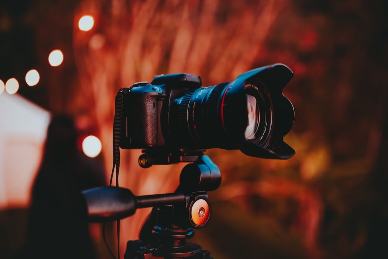 A DSLR camera with tripod in focus