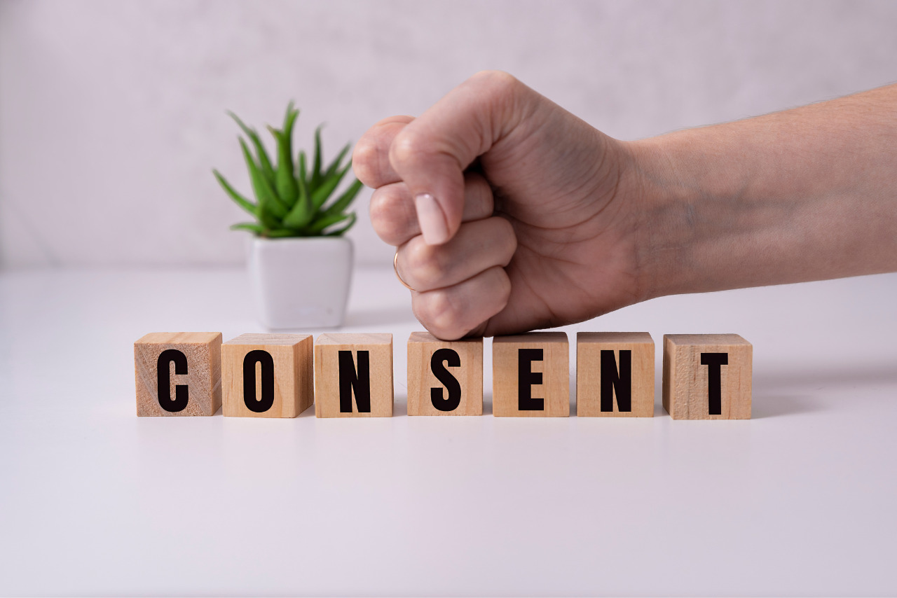 Consent - word from wooden blocks with letters, consent concept, top view on white background.