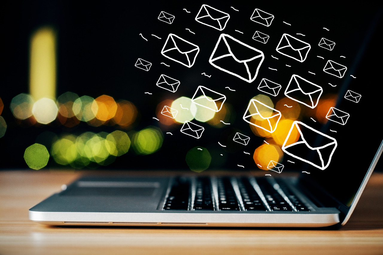 A laptop with multiple email icons hovering above it.