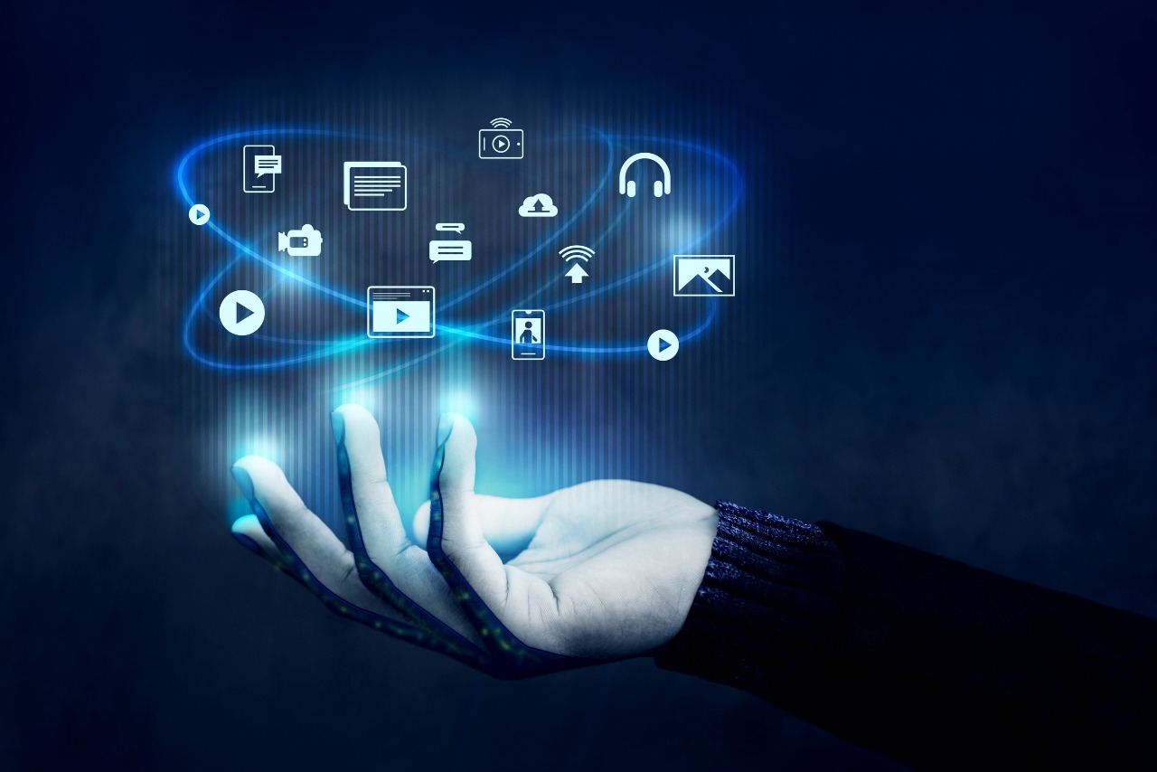 Different content icons floating over a hand, side view.