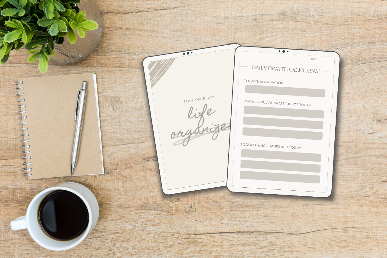 Two types of digital planners (daily and specialty) displayed on an iPad, set on a table with a cup of coffee.
