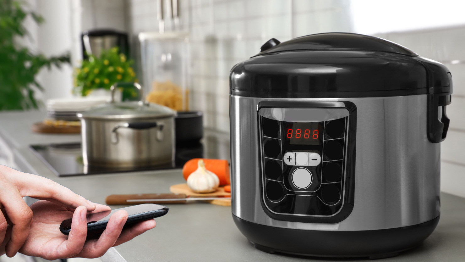 Smartphone controlled slow cooker on a kitchen top.