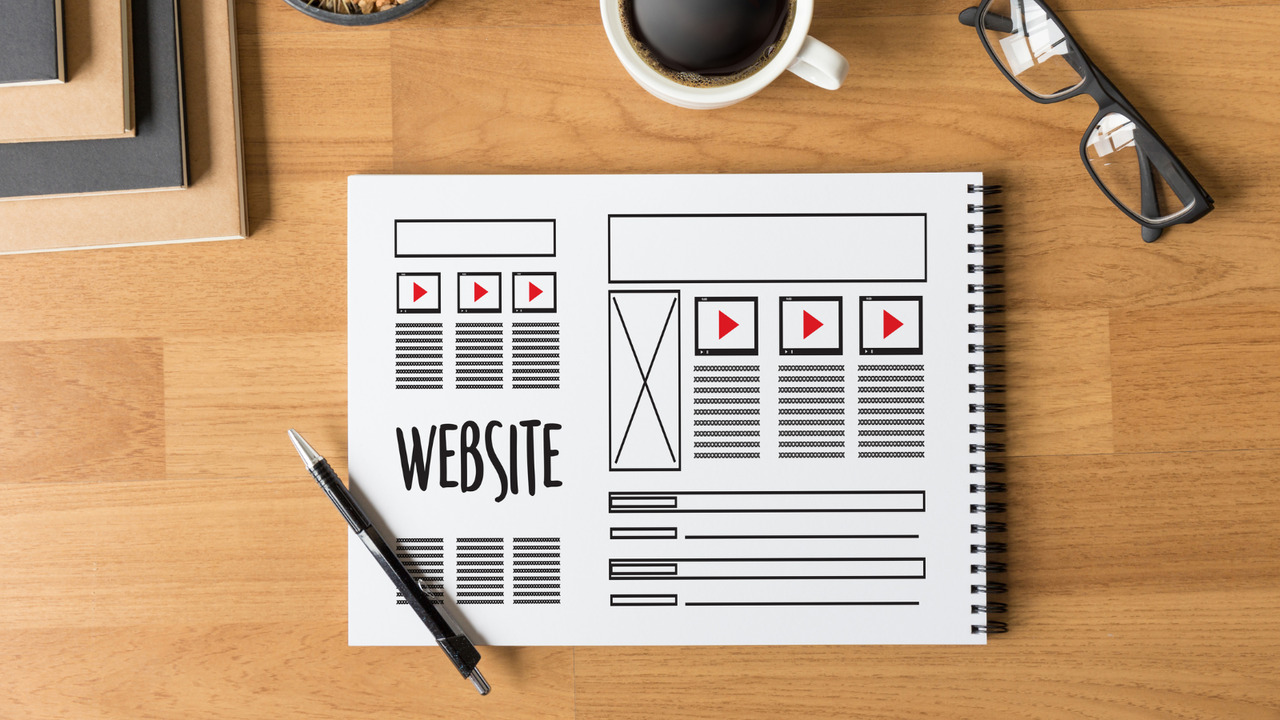 Website designer working layout sketch matching brand.