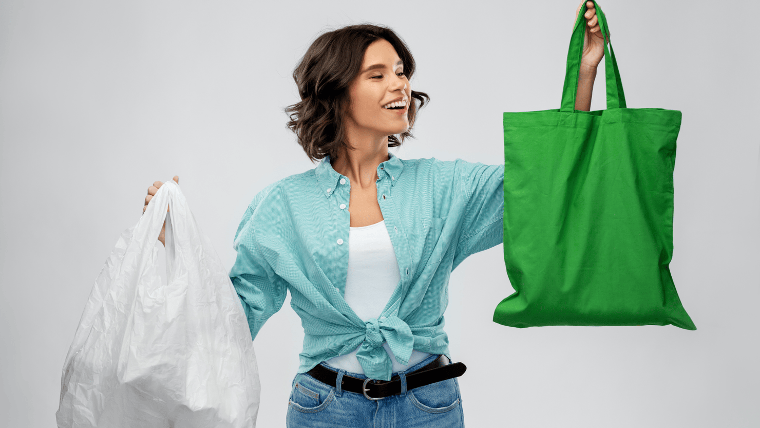 Woman with plastic and reusable shopping bag, showing consumers growing concern on sustainability.