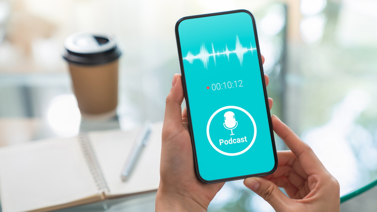 Woman holding smartphone and listening podcast.