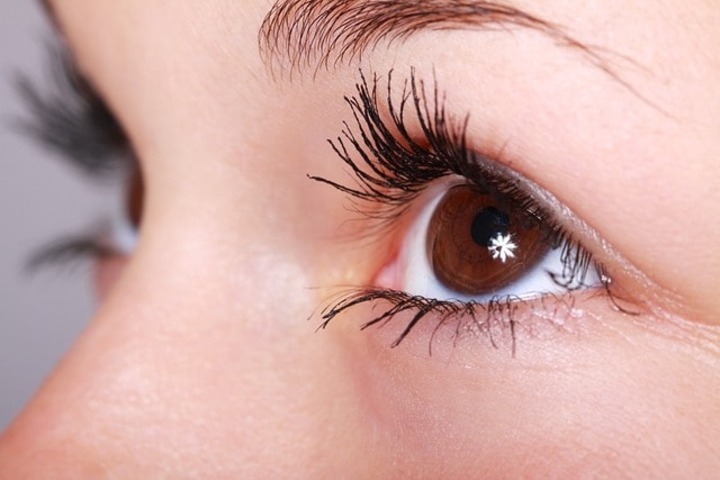 A woman with her eyelashes as the point of focus.