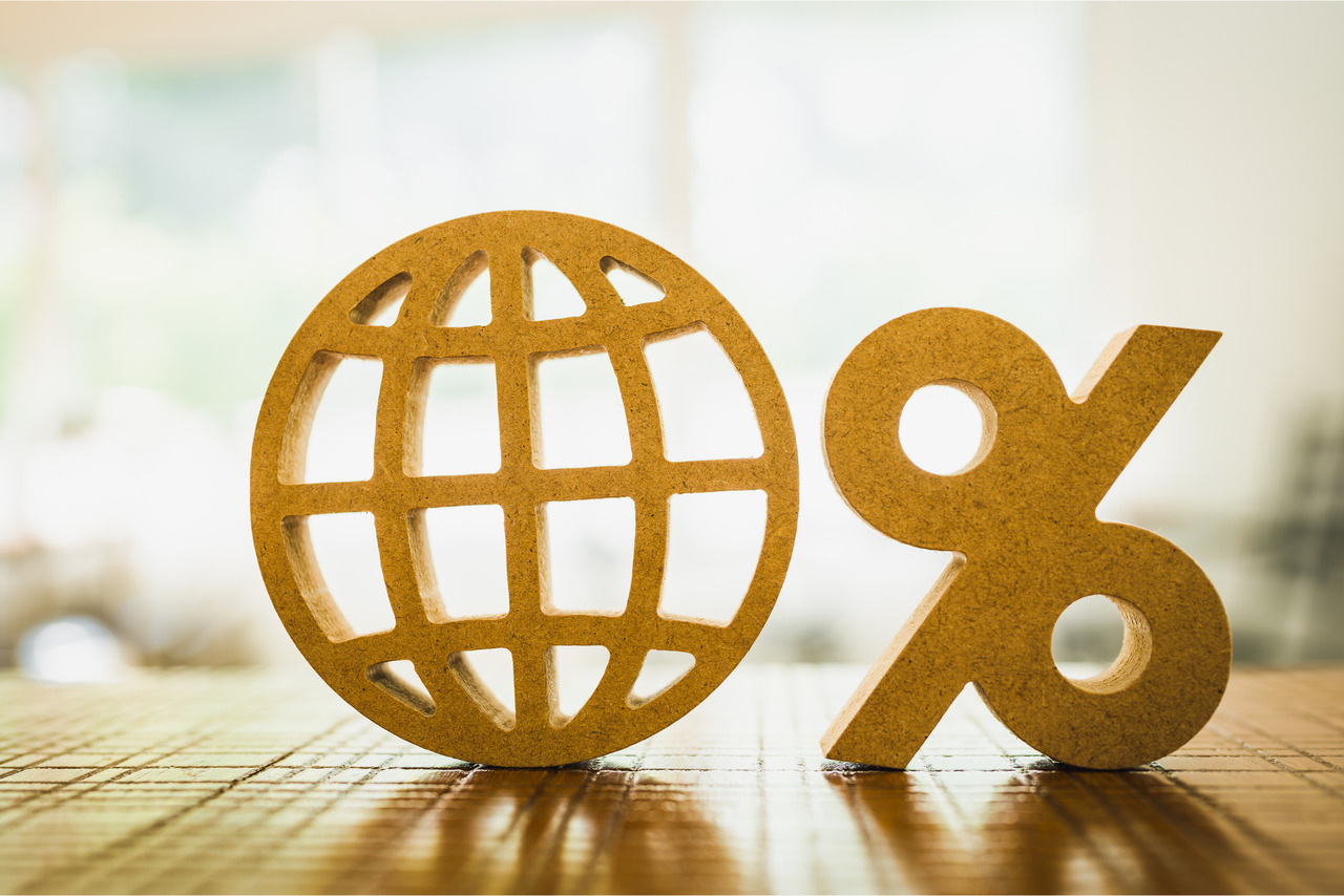 Percentage and Globe model on wood table.