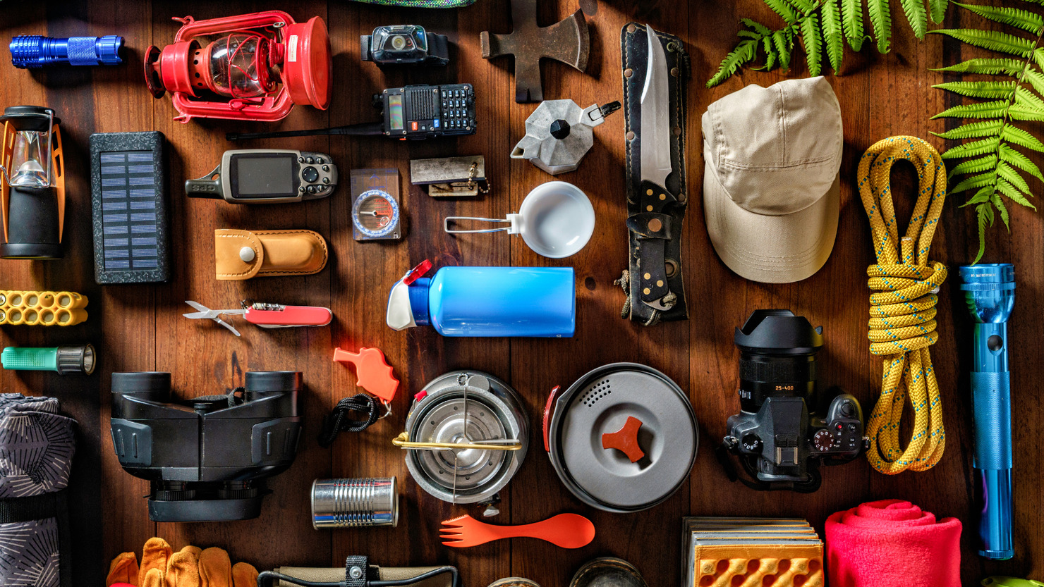 Top view camping and hiking travel and hiking gear, equipment and accessories for mountain trips.