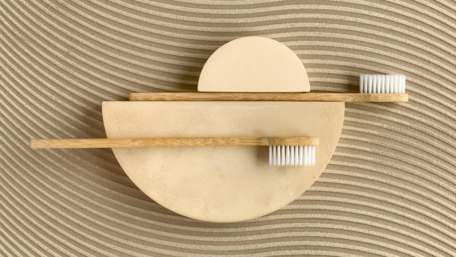 Eco bamboo toothbrushes on concrete sands.