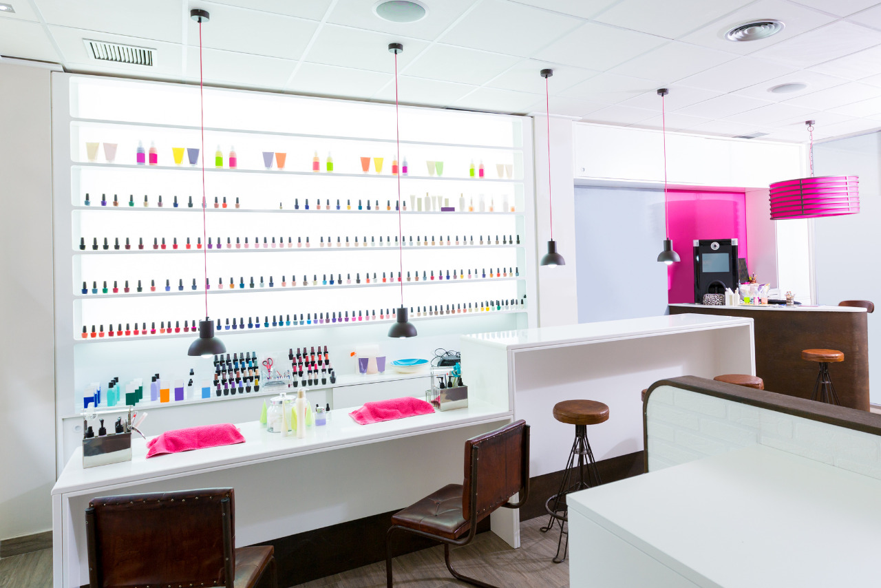 A modern and simplistic nail salon featuring pink accents.