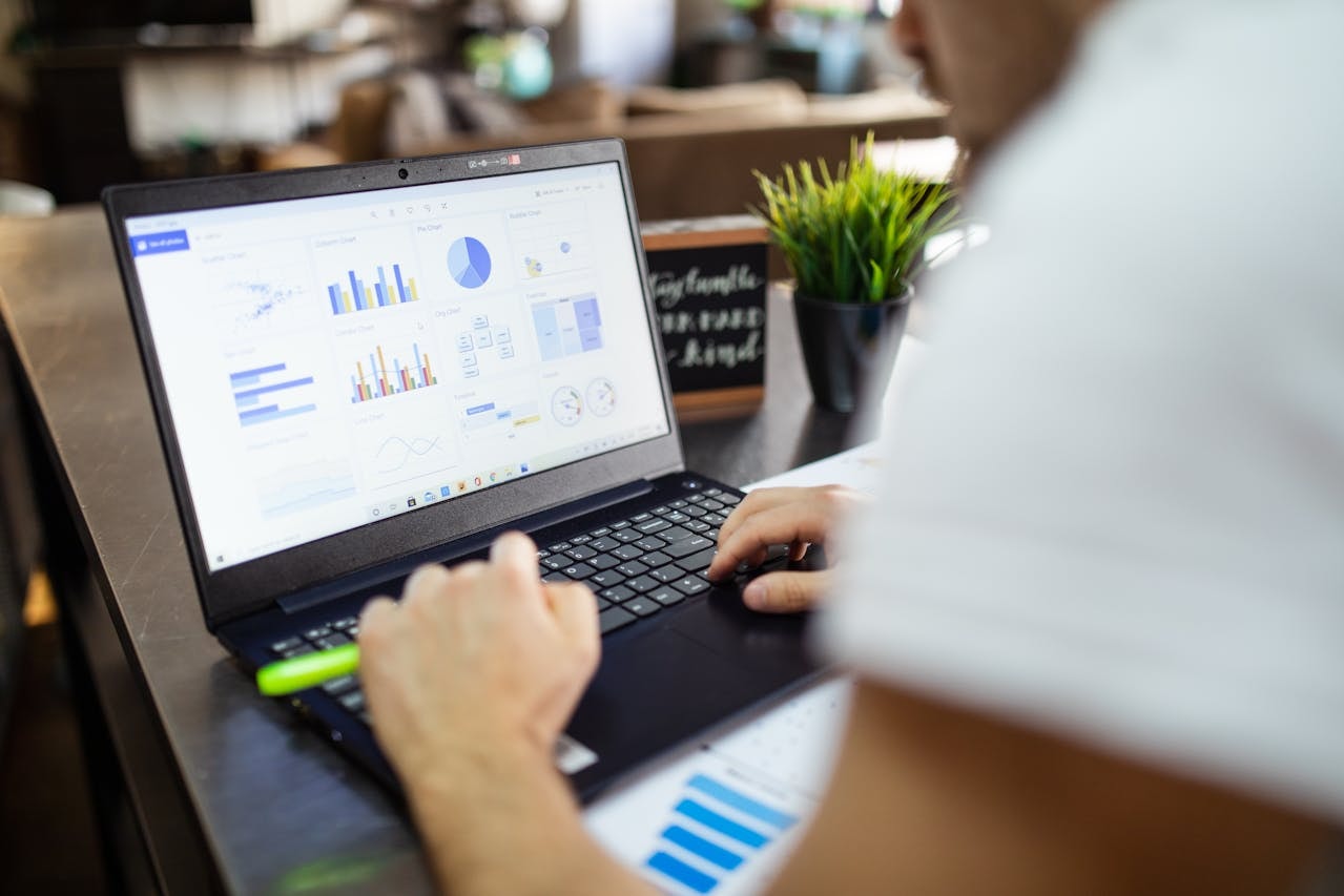A person looking at metrics on a laptop