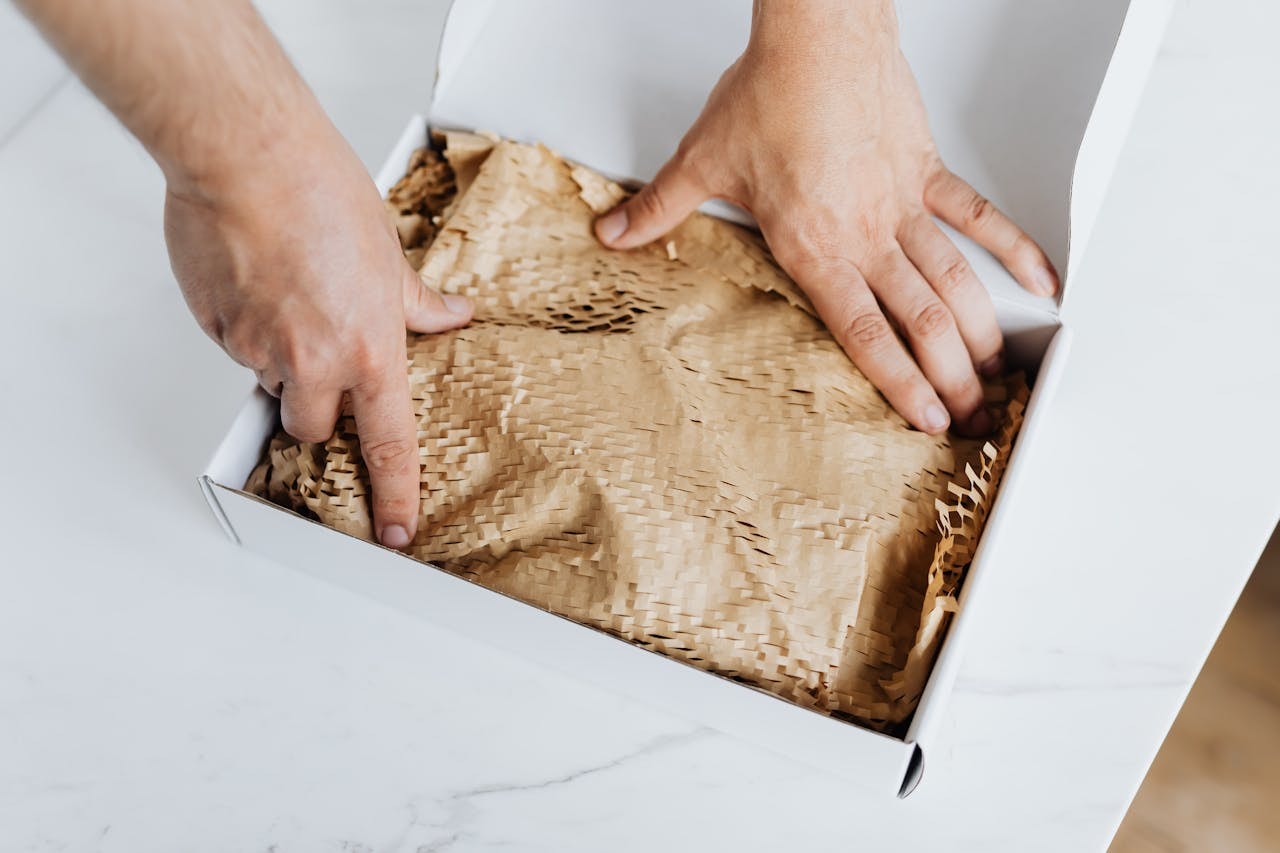 A person packing an item for shipment