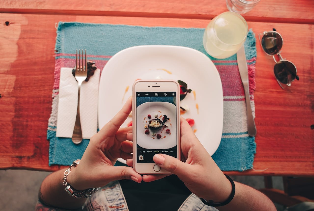 A person taking a photo of food