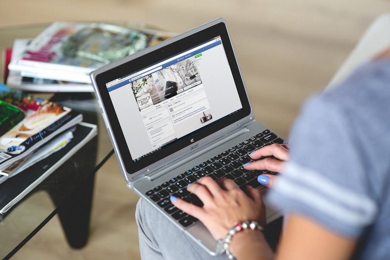 A person using Facebook on a laptop