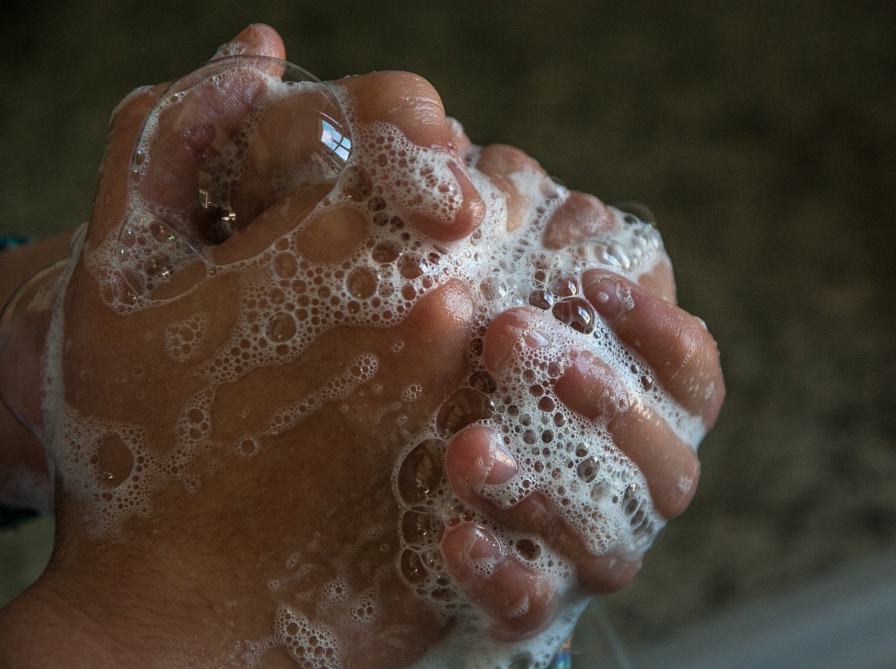 A person washing their hands with soap.
