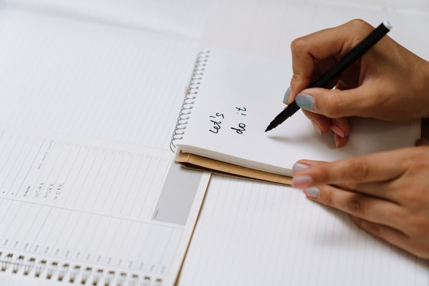 A person writing in a notebook