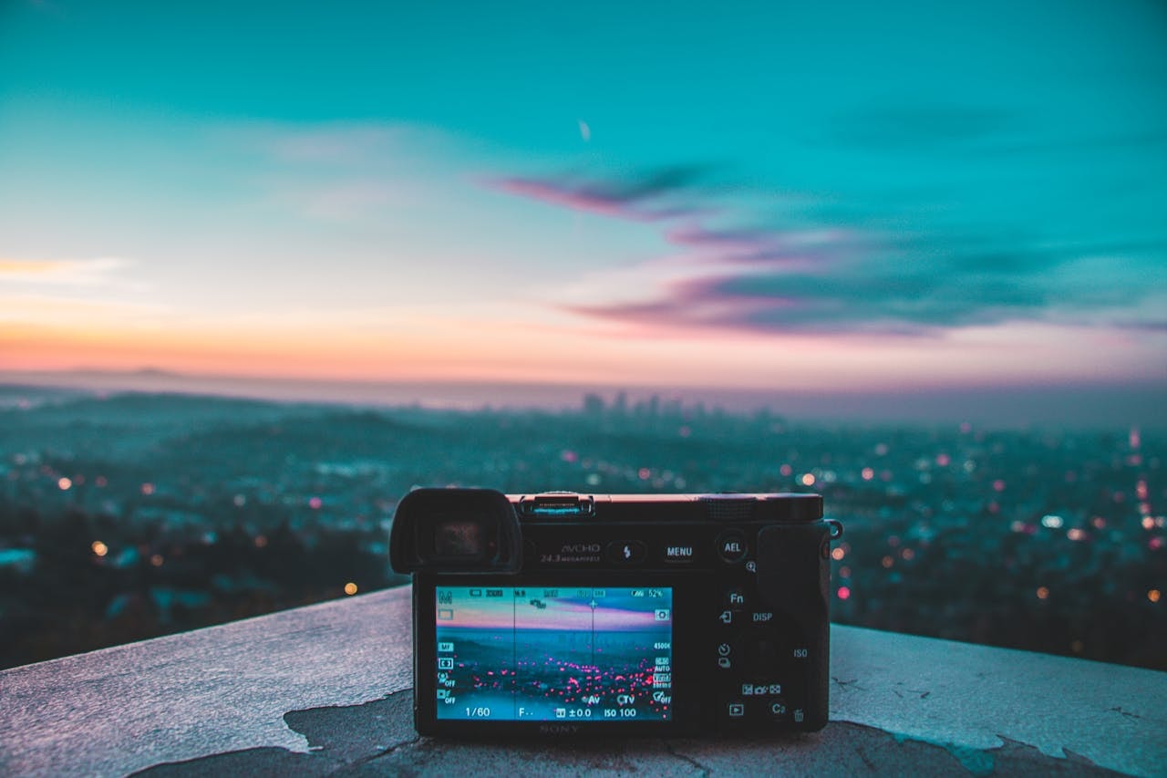 A photo of a camera on a rooftop capturing a city landscape