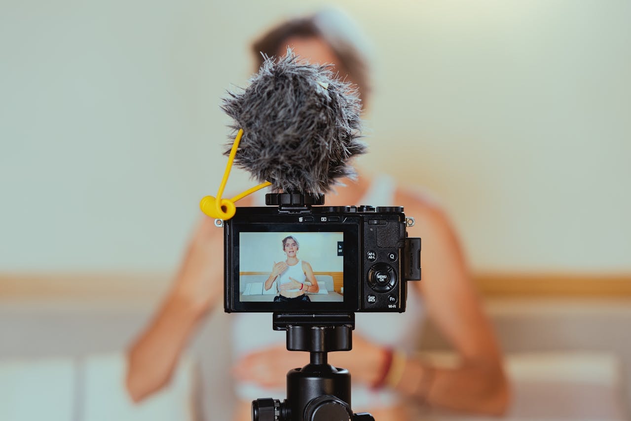 A photo of a video camera recording a woman