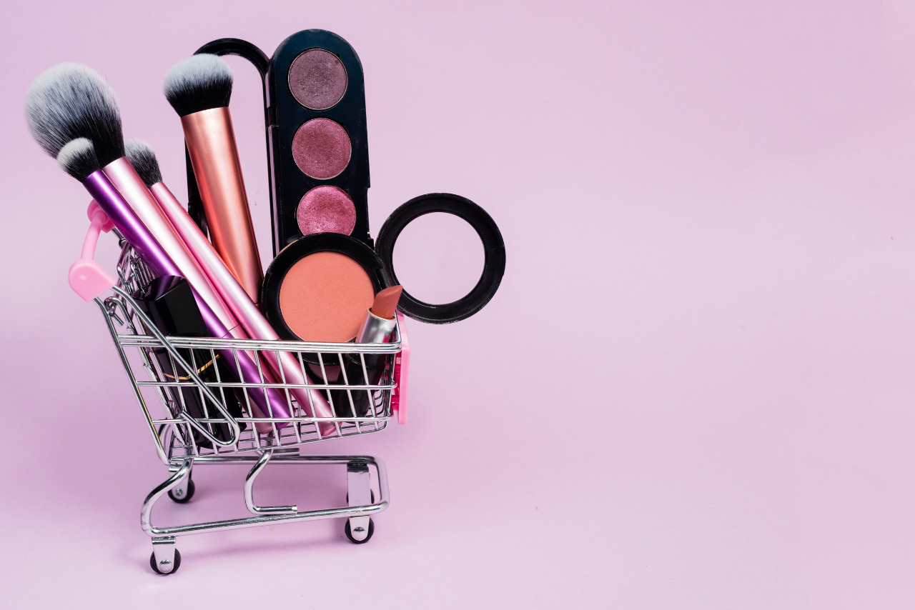 A small shopping cart filled with makeup products.
