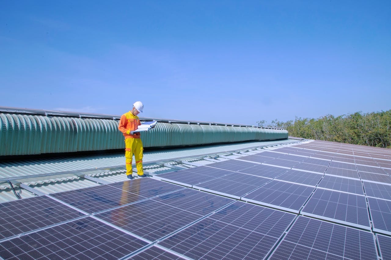 A solar technician installing solar panels