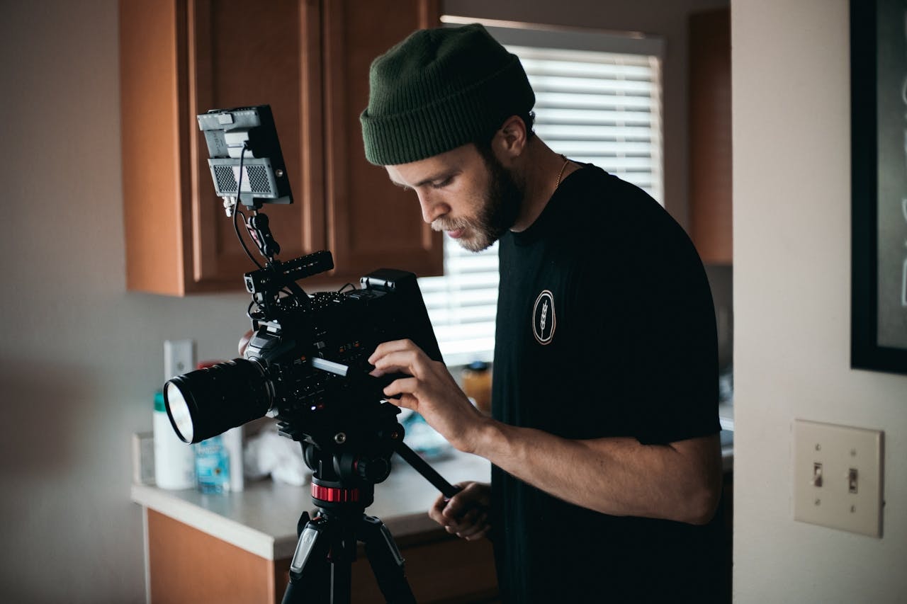 A videographer setting up the camera