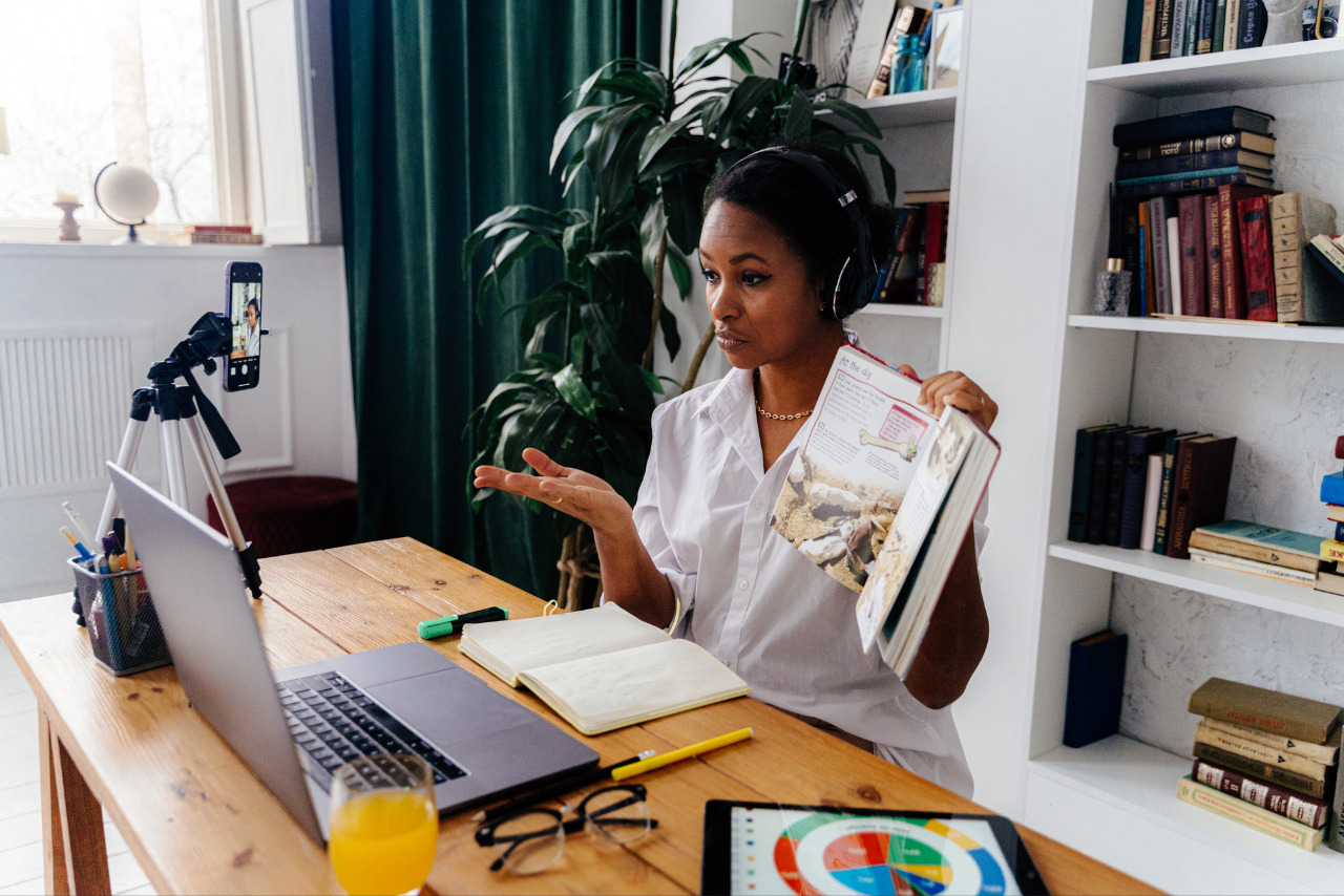 A woman hosting an online book forum, introducing a reader to a book.