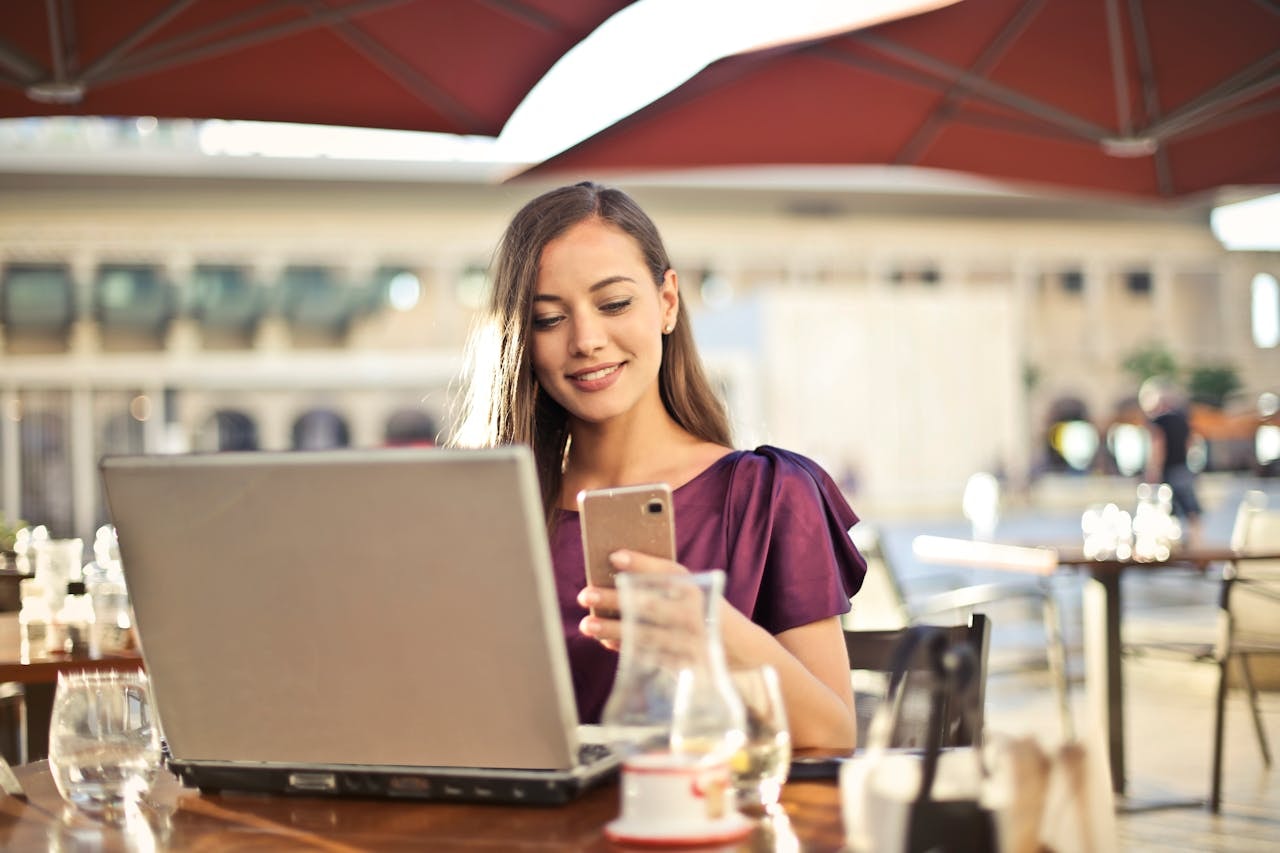 A woman smiling and looking at her mobile phone