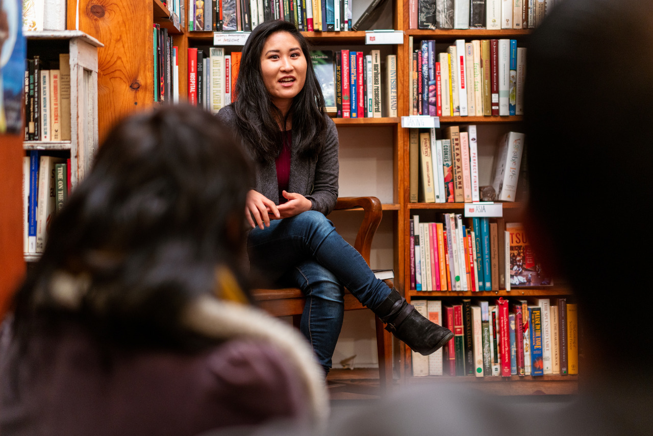 Author discusses book with small audience in a bookstore.