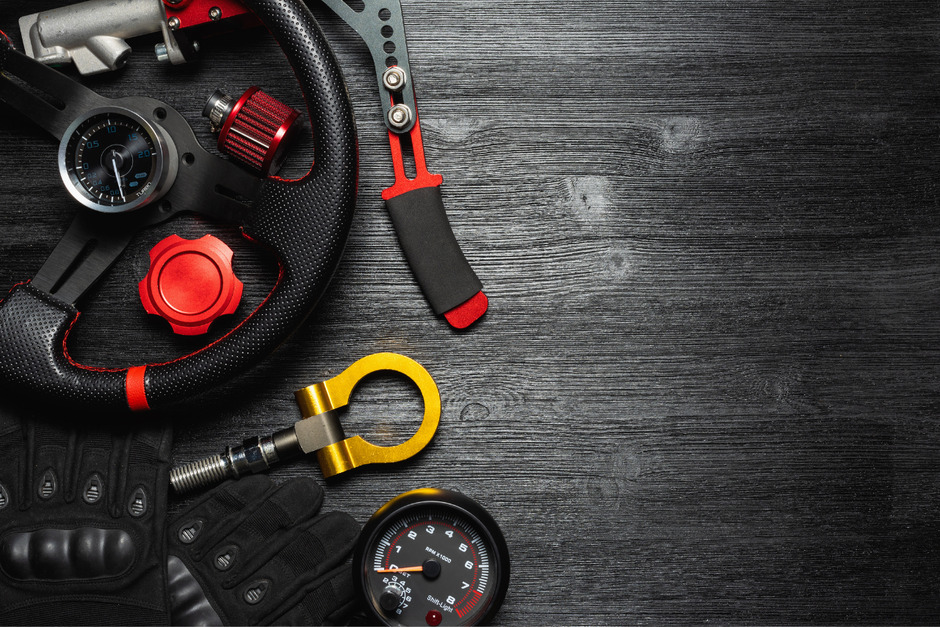 Car tuning and accessories on black wooden table.