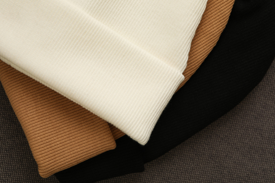 Closeup of stylish beanies and cotton.