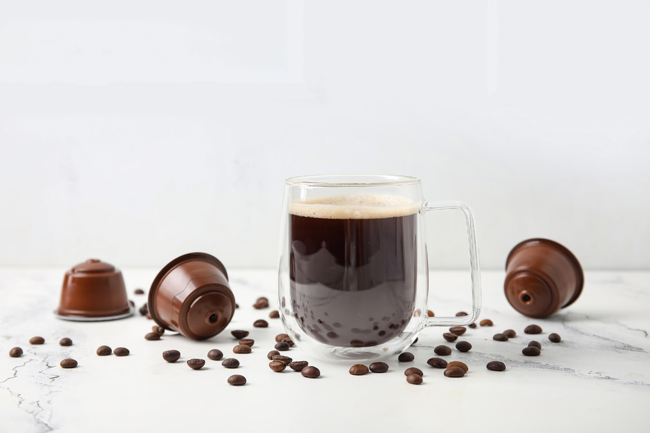 Coffee with empty pods and beans.