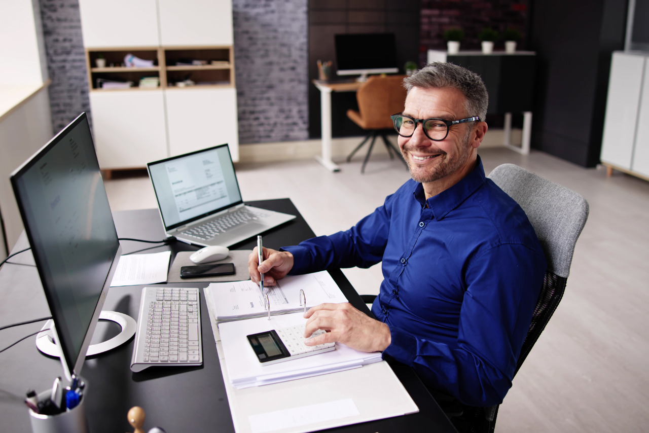 Male accounting bookkeeper working from office.