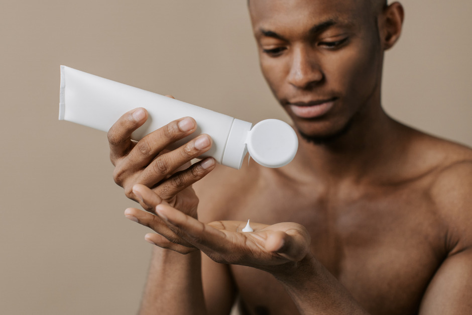 Man putting moisturizing lotion on palm.