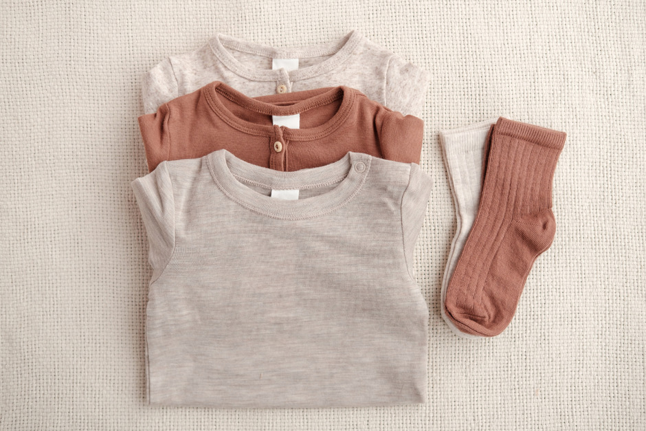Organic baby shirts and socks laid out.