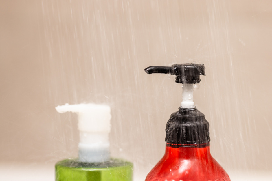 Over the bottle of shampoo and body wash.