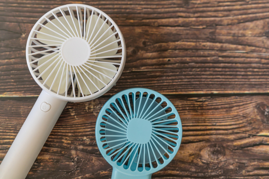 Portable handheld fans for keeping cool in summer.