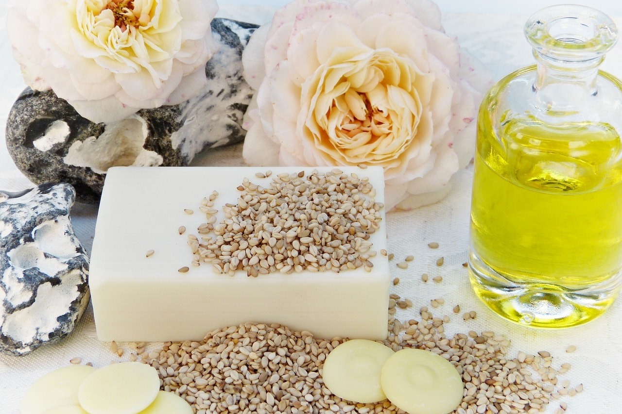 Sesame seeds, roses and olive oil used as ingredients for making soap.