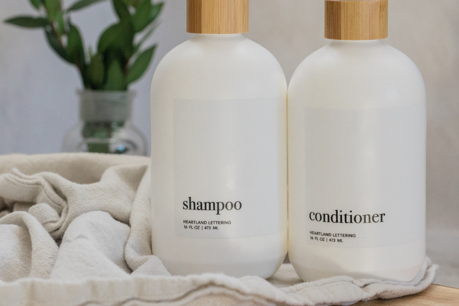 Shampoo and conditioner bottles on a table.
