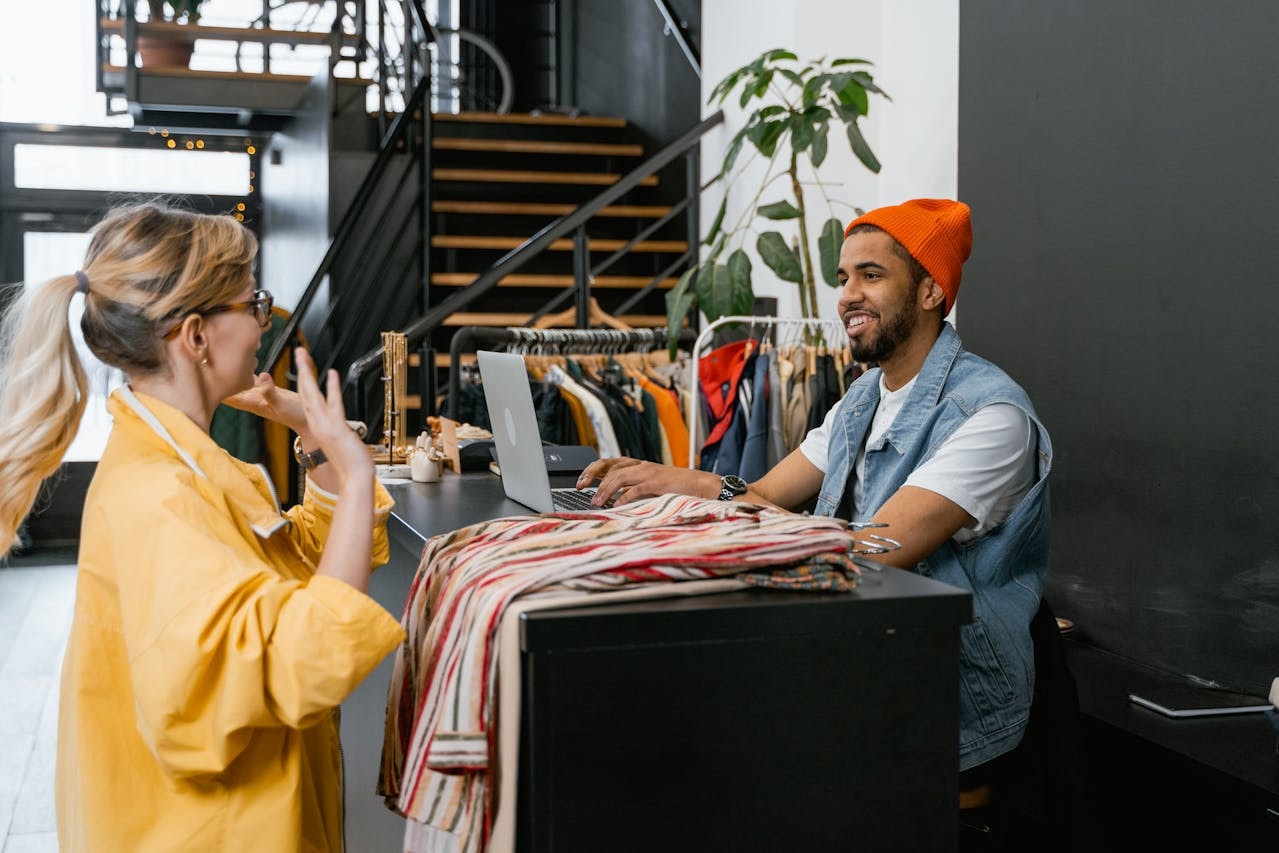 Staff at a clothing store talking to a customer