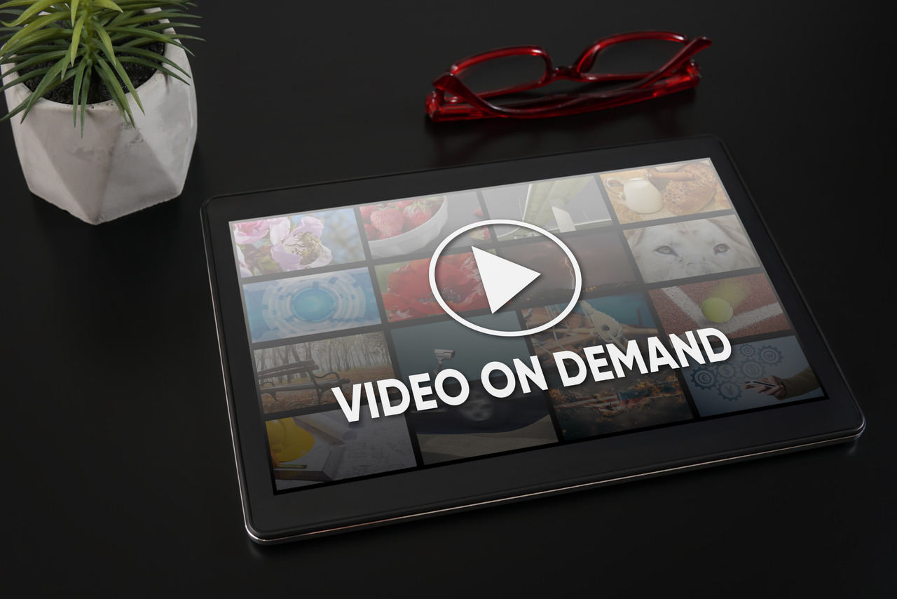 Tablet on table with video-on-demand on screen.